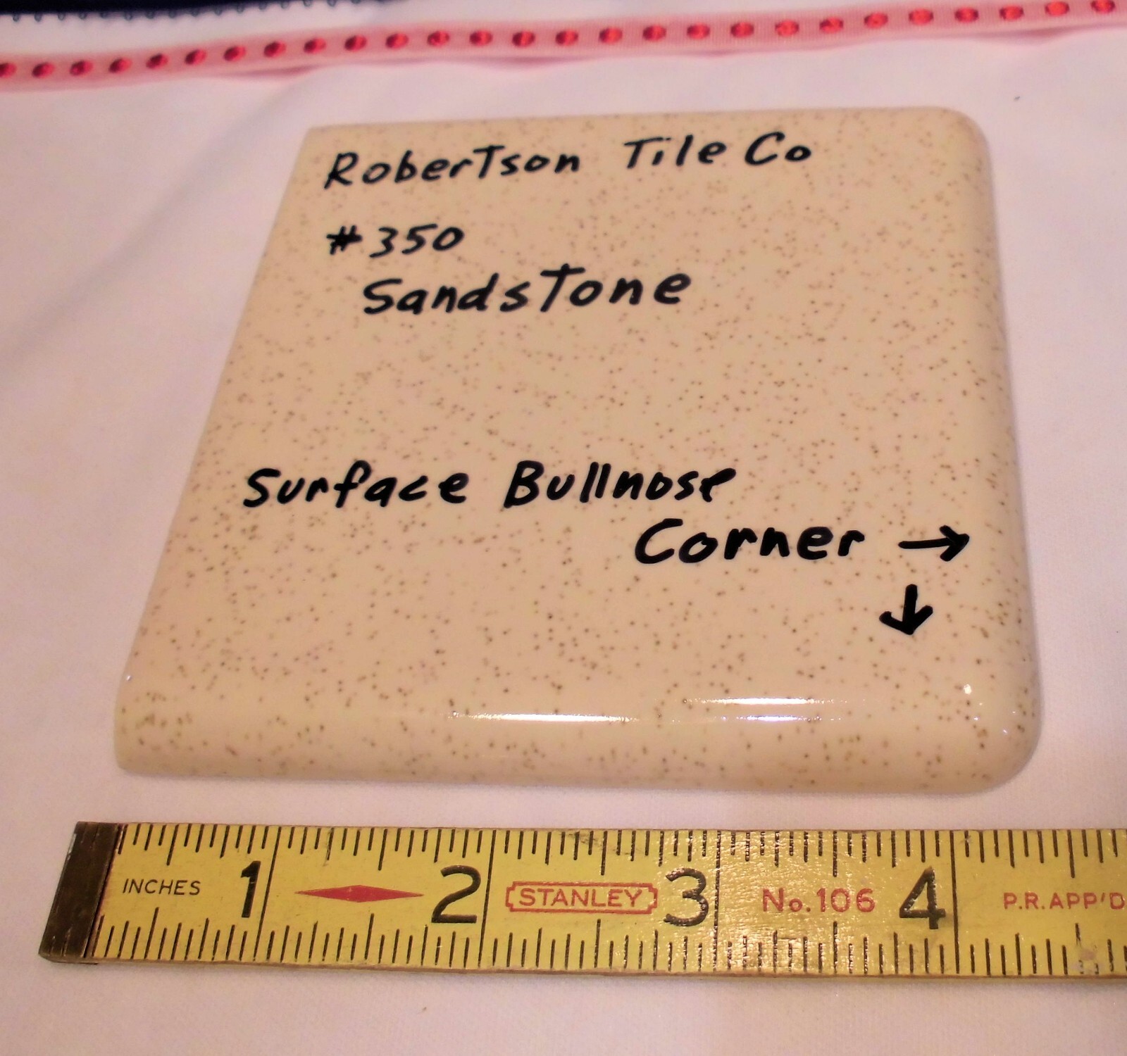 1 pc. Sandstone / Buckwheat: Glossy Ceramic Corner Bullnose Tile by Robertson Co