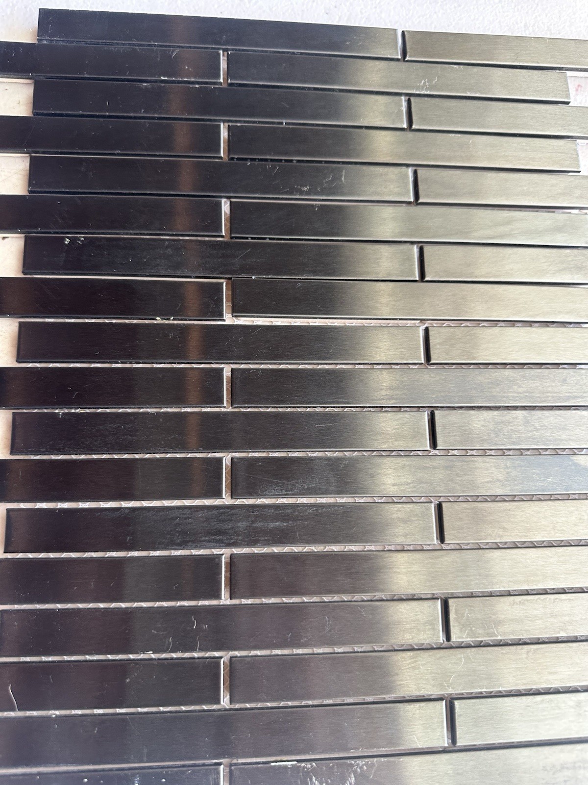 Black Aluminum Brushed Mosaic Tile .5×6 Inch On CeramicTile Backing Mesh Mounted