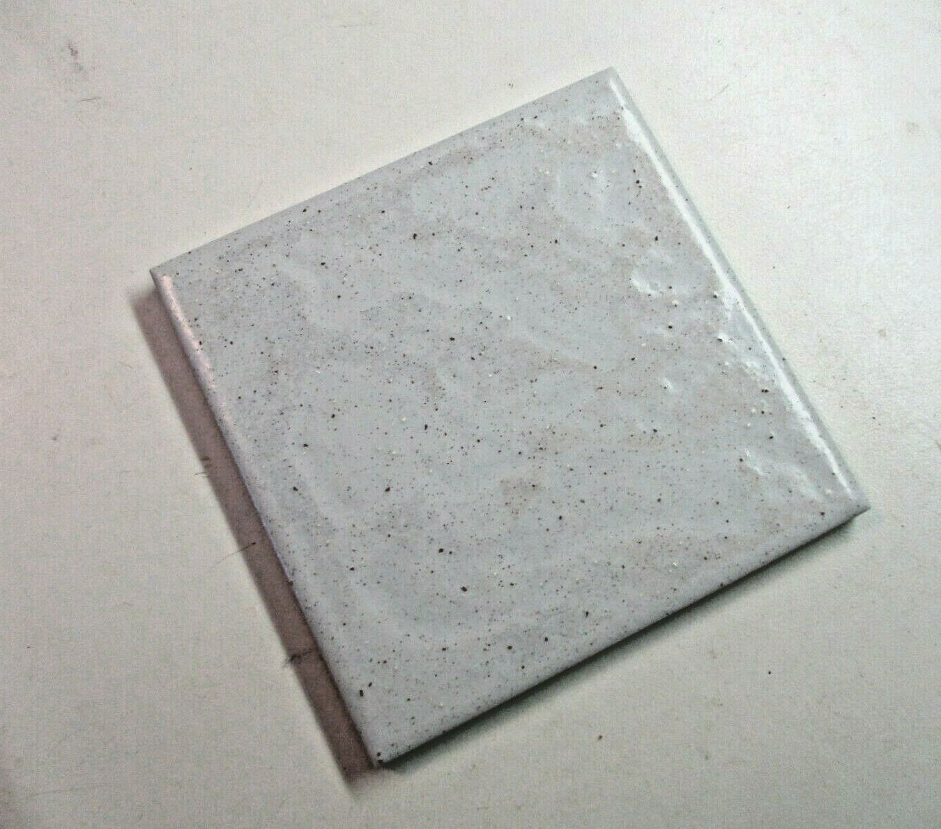 1 Tile interceramic 4-1/4″sq Satin Brown Speckles on Pale Gray Wrinkled Wall MCM