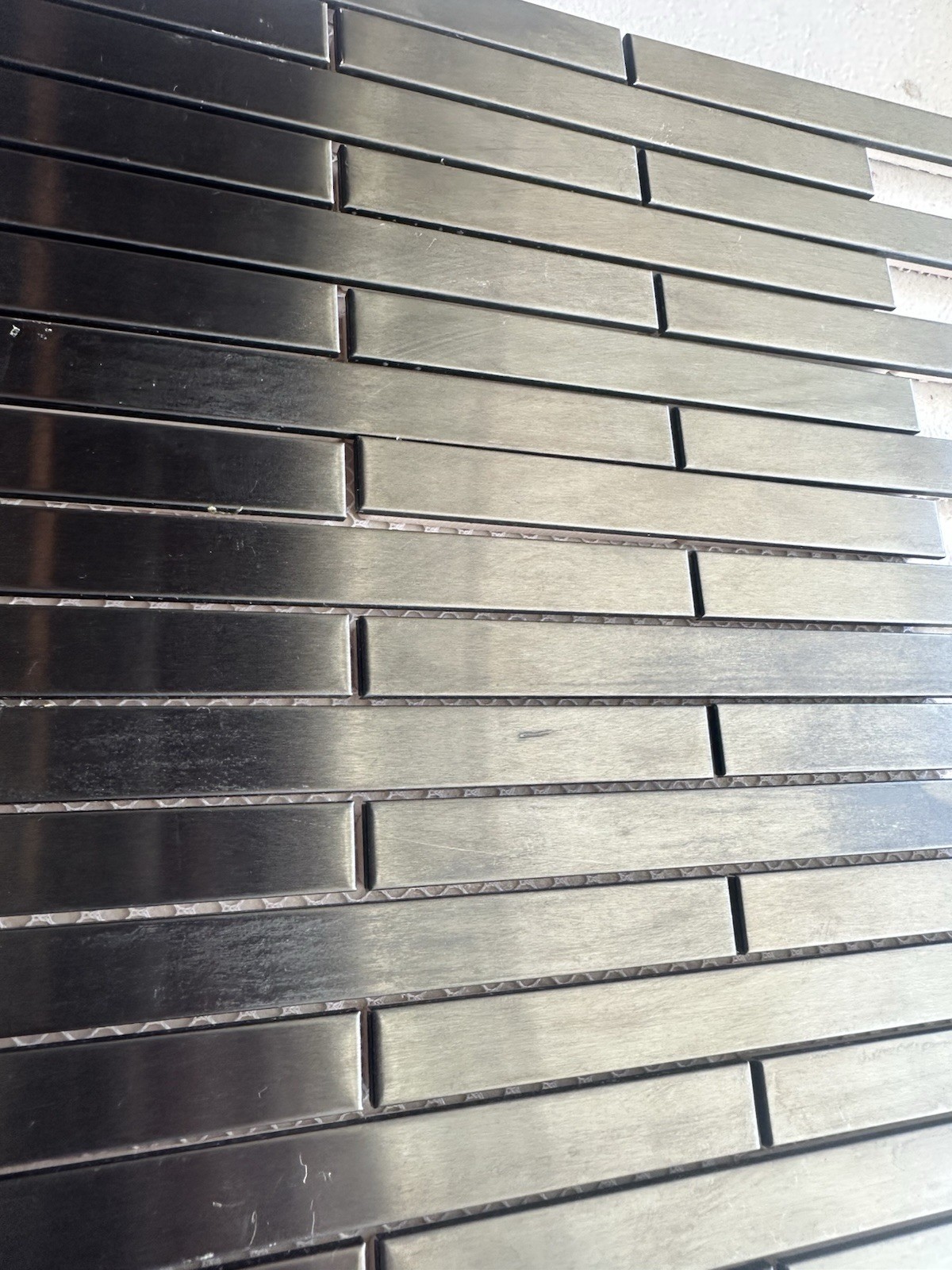 Black Aluminum Brushed Mosaic Tile .5×6 Inch On CeramicTile Backing Mesh Mounted