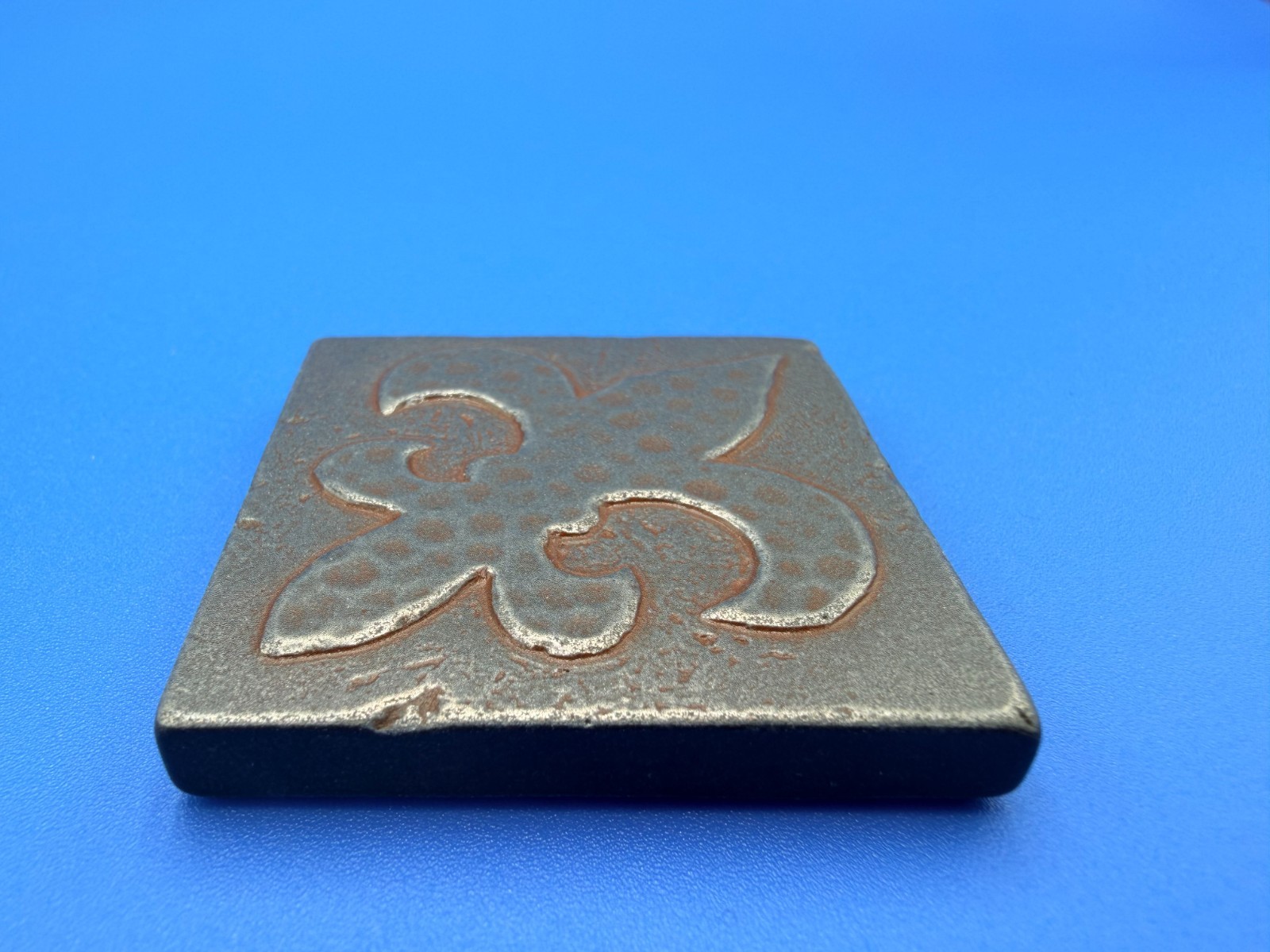 New Questech 2×2 Fleur-de-lis Insert Accent Composite Tile w/ Aged Iron Finish