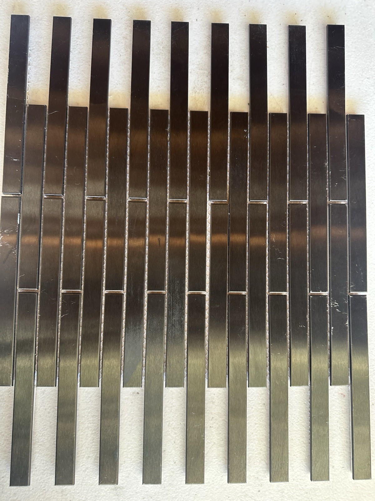 Black Aluminum Brushed Mosaic Tile .5×6 Inch On CeramicTile Backing Mesh Mounted