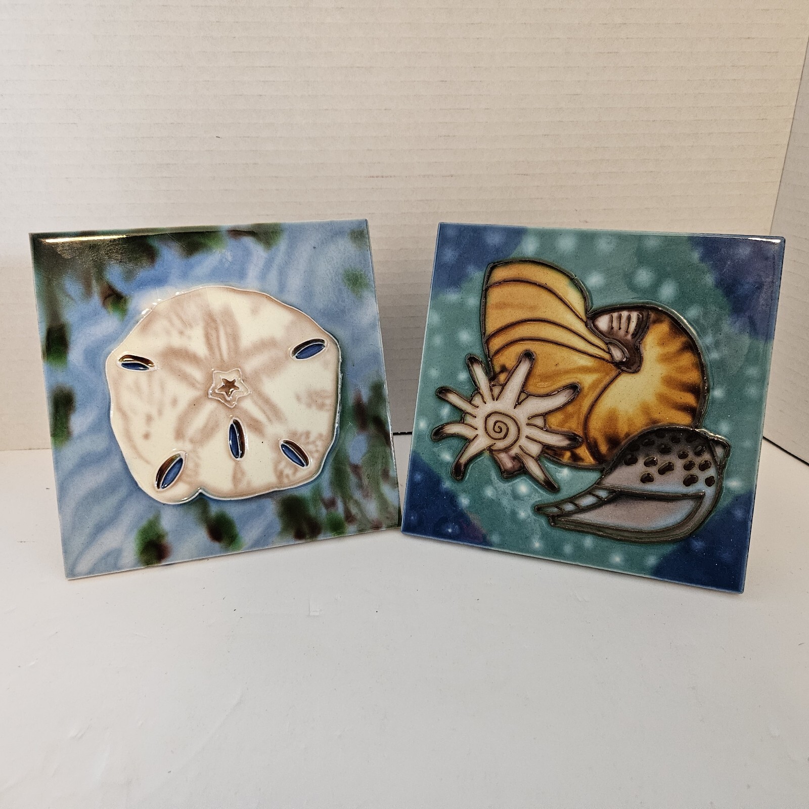 2 Nautical Art Tiles Built In Stands 3 Sea Shells AND A sand Dollar 6×6″ Blue