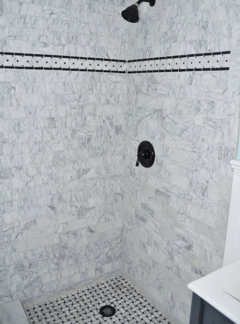 C651BXH Carrara Venato Marble Basketweave Mosaic Border 4×12 Black Dots Honed