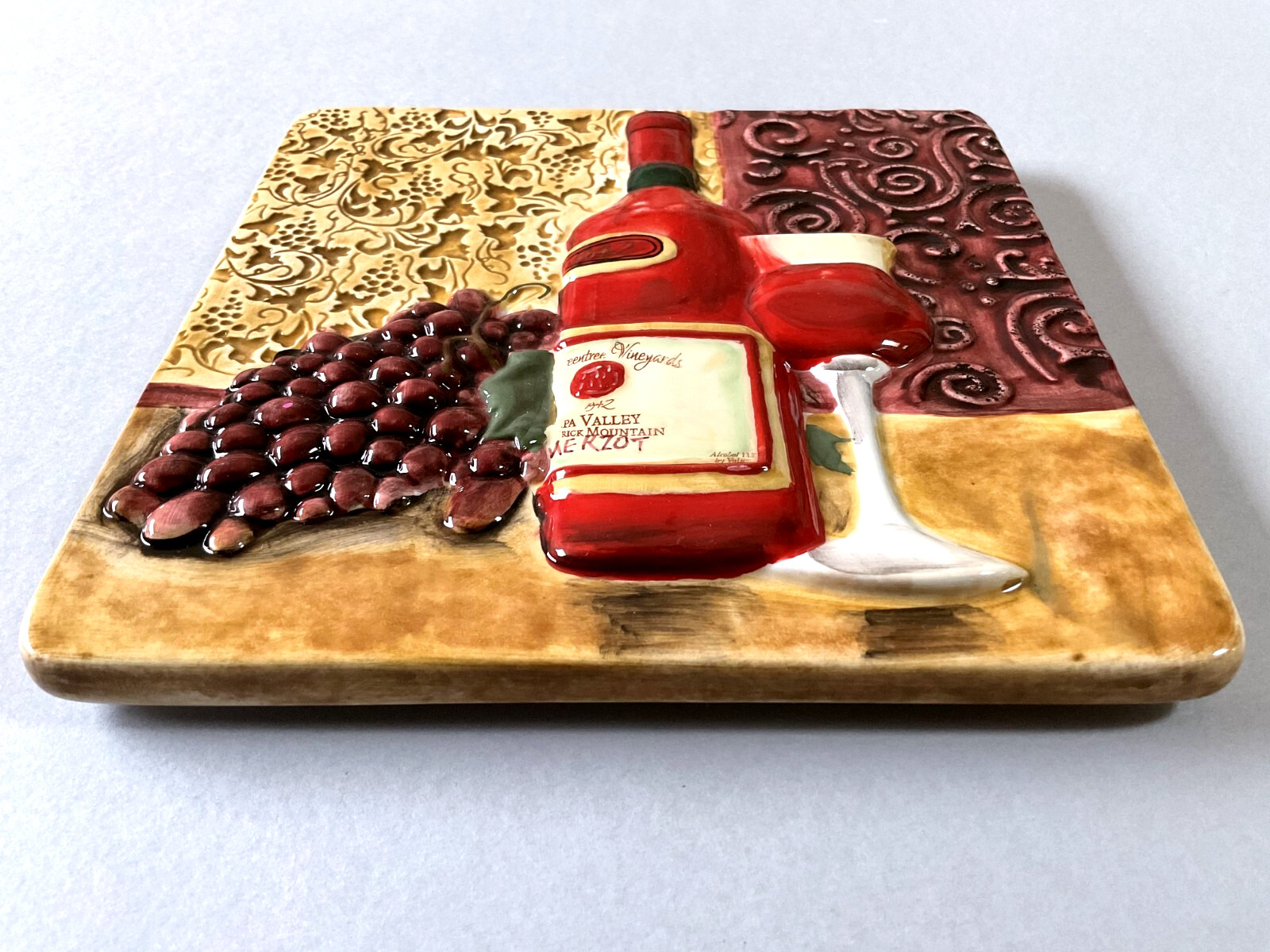 A Raised Relief Ceramic Wall Tile/ Trivet with a Wine Theme 7 1/2″ x 7 1/2″