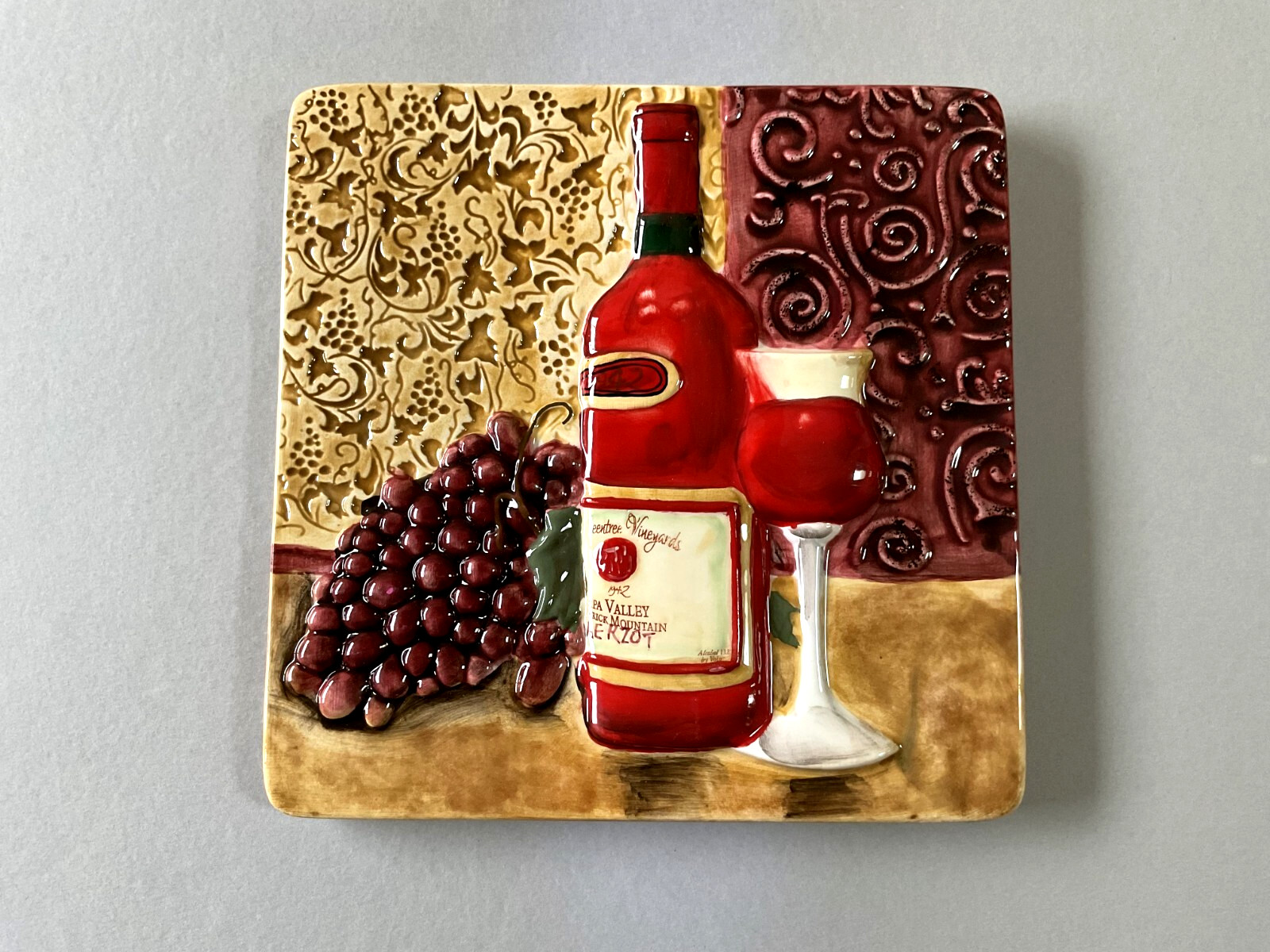 A Raised Relief Ceramic Wall Tile/ Trivet with a Wine Theme 7 1/2″ x 7 1/2″